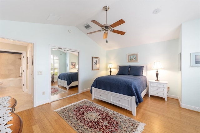 bedroom with vaulted ceiling, light wood-style flooring, visible vents, and baseboards