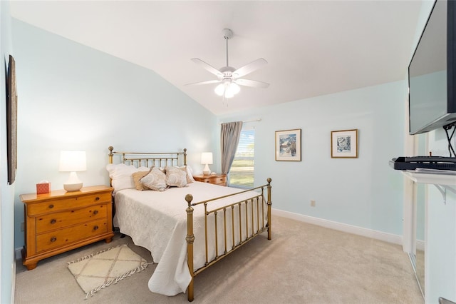 bedroom featuring lofted ceiling, baseboards, a ceiling fan, and light colored carpet