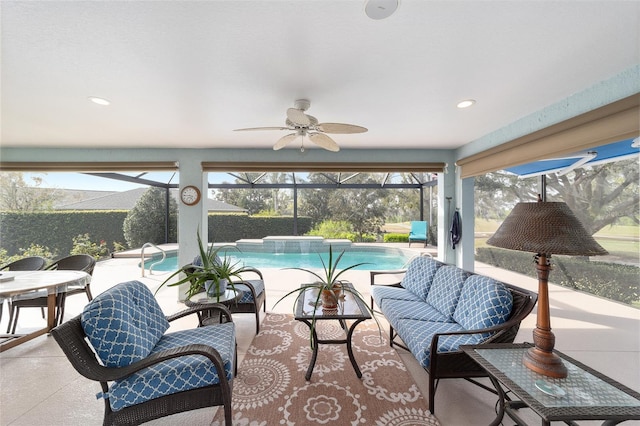 sunroom / solarium featuring a ceiling fan