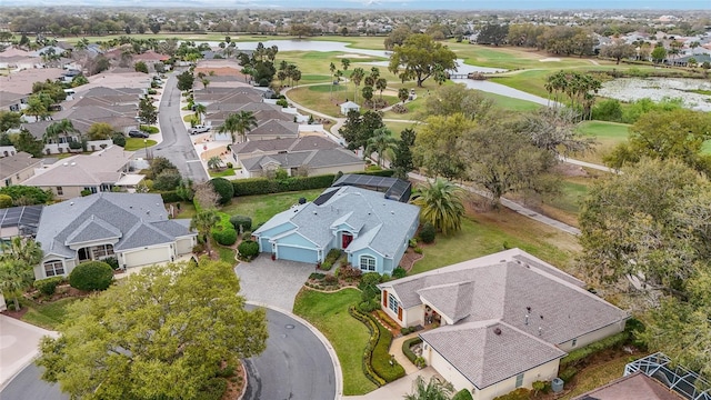 bird's eye view with view of golf course, a water view, and a residential view