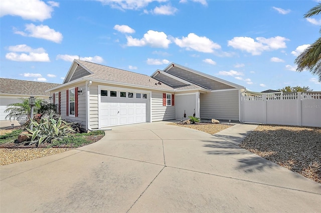 single story home with a gate, driveway, an attached garage, and fence