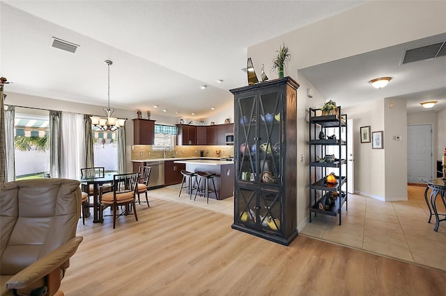 dining area with a healthy amount of sunlight, light wood-style floors, and visible vents