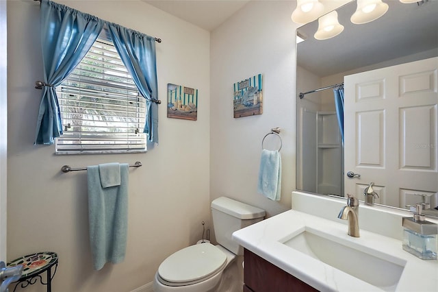 bathroom with a shower, vanity, and toilet