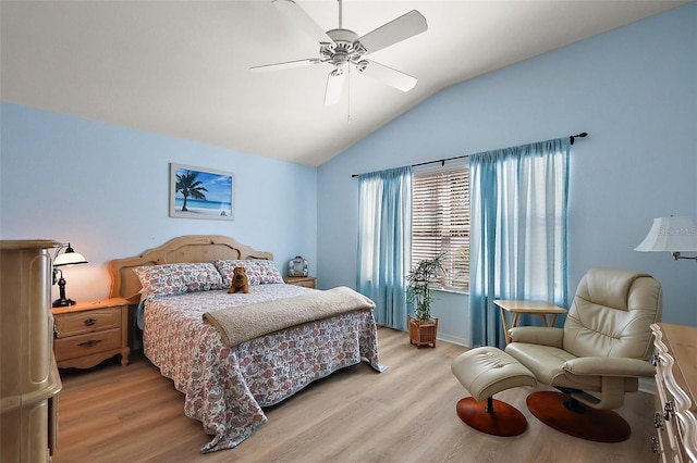 bedroom featuring light wood-style floors, lofted ceiling, and a ceiling fan