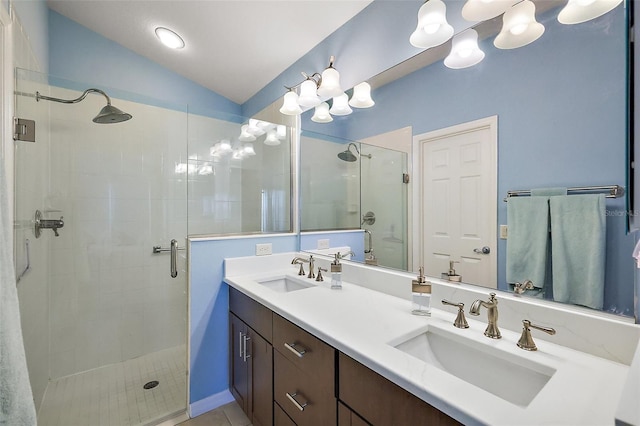 bathroom with a stall shower, vaulted ceiling, a sink, and double vanity