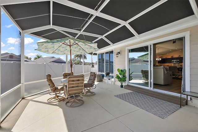 view of patio / terrace with glass enclosure and fence