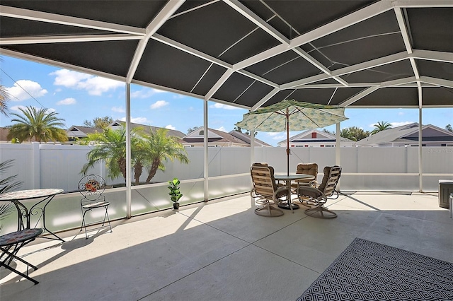 view of patio / terrace featuring outdoor dining space, fence, and a lanai