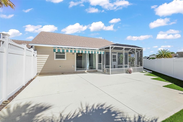 rear view of property with a patio, a fenced backyard, and a sunroom