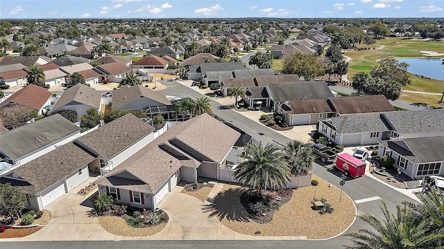 aerial view with view of golf course, a water view, and a residential view