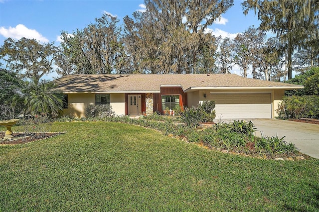 ranch-style home with a garage, stucco siding, concrete driveway, and a front yard