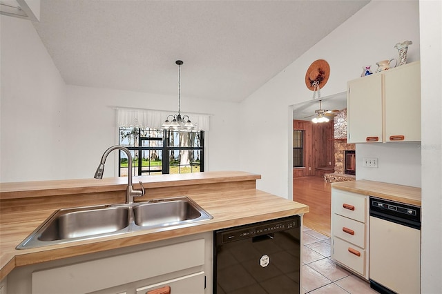 kitchen with black dishwasher, a fireplace with raised hearth, hanging light fixtures, vaulted ceiling, and a sink