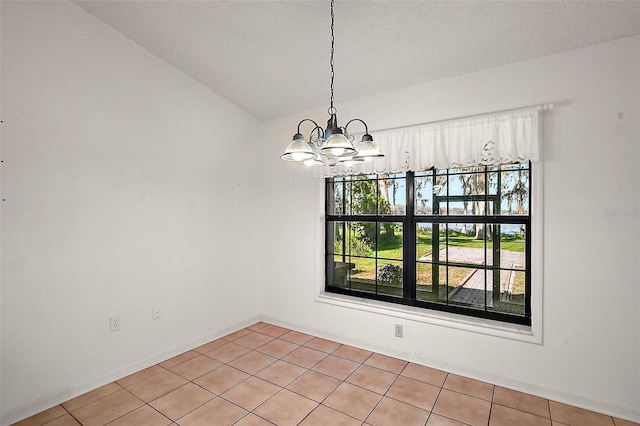 unfurnished dining area featuring a chandelier