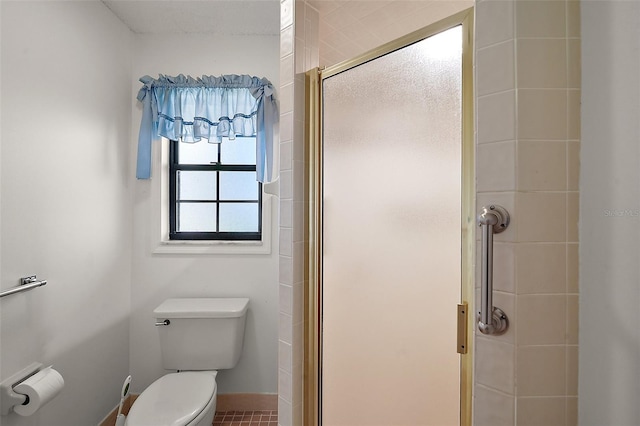 full bathroom with toilet and a stall shower