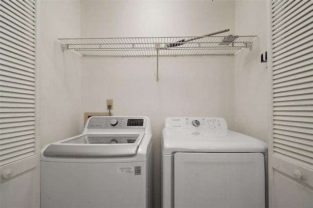 clothes washing area featuring washer and dryer and laundry area