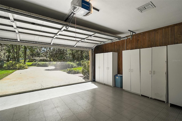 garage featuring visible vents and a garage door opener