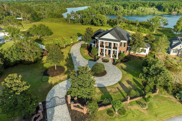 drone / aerial view with a water view and a forest view