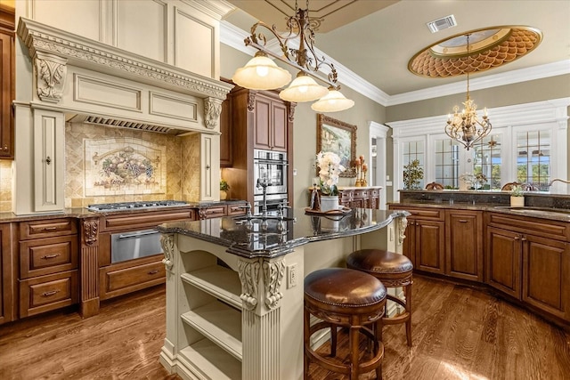 kitchen featuring visible vents, dark wood-type flooring, crown molding, a sink, and a warming drawer