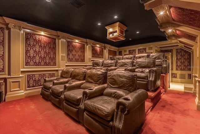 cinema with visible vents, a decorative wall, carpet flooring, and ornamental molding