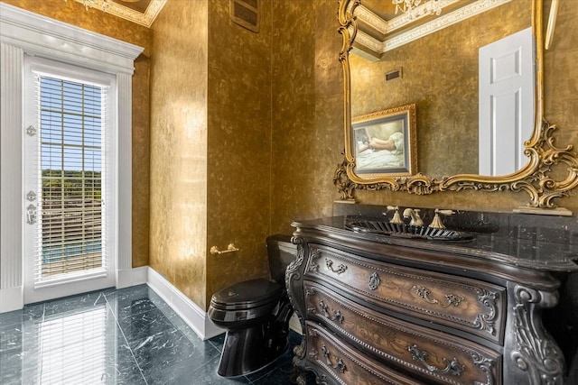 half bath with marble finish floor, visible vents, toilet, ornamental molding, and baseboards