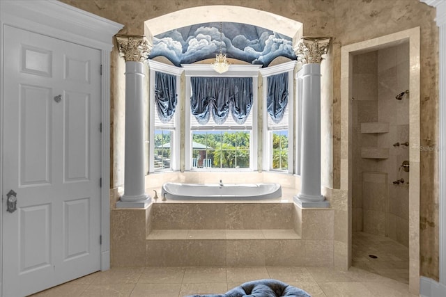 bathroom with tiled shower, a garden tub, and decorative columns