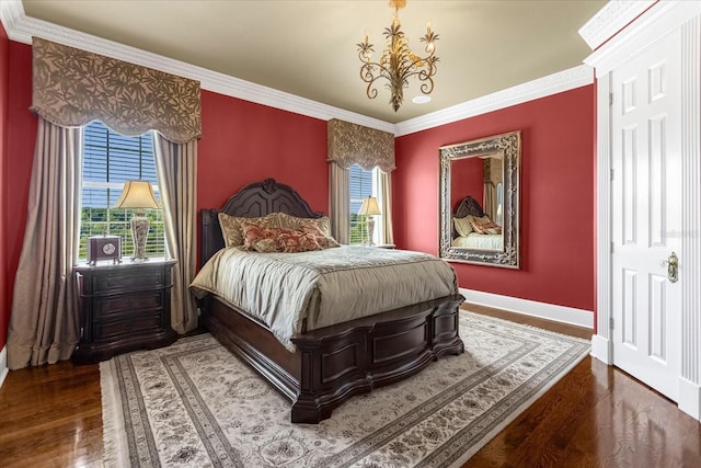 bedroom with crown molding, a notable chandelier, wood finished floors, and baseboards