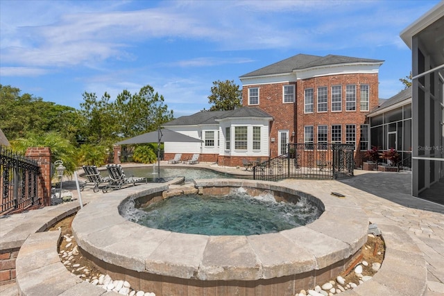 view of pool with a patio and an in ground hot tub