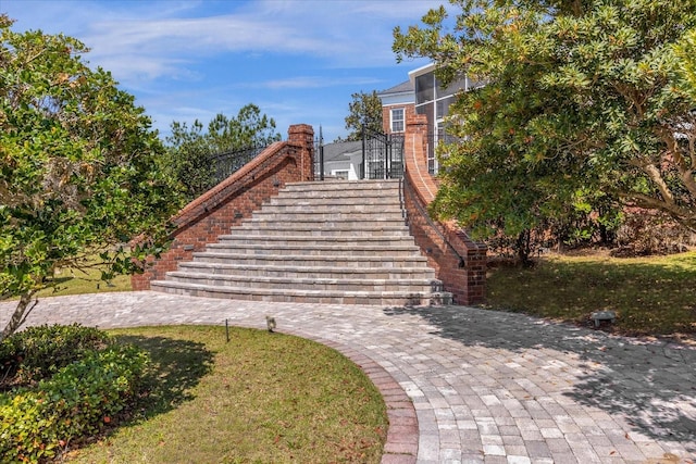 view of property's community featuring stairway and a yard