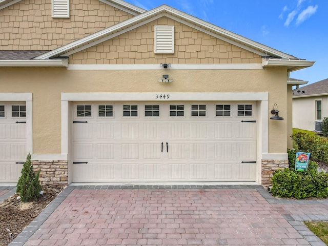 garage featuring decorative driveway