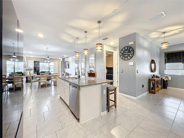 kitchen featuring a sink, visible vents, open floor plan, and dishwasher