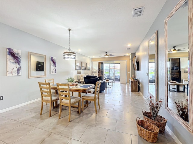 dining room featuring light tile patterned floors, baseboards, visible vents, and ceiling fan