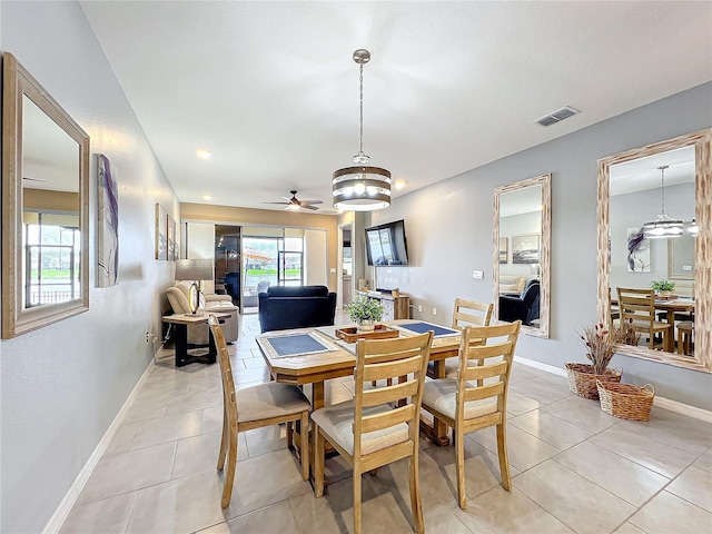 dining space featuring light tile patterned floors, baseboards, visible vents, and a ceiling fan