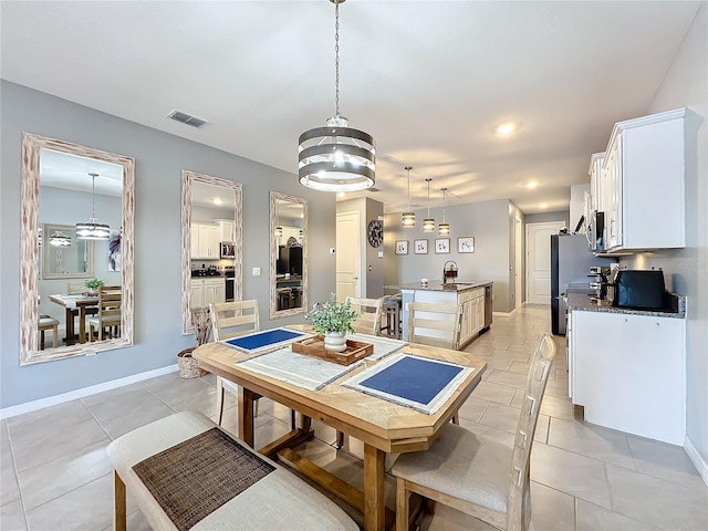 dining room with visible vents, baseboards, and light tile patterned flooring