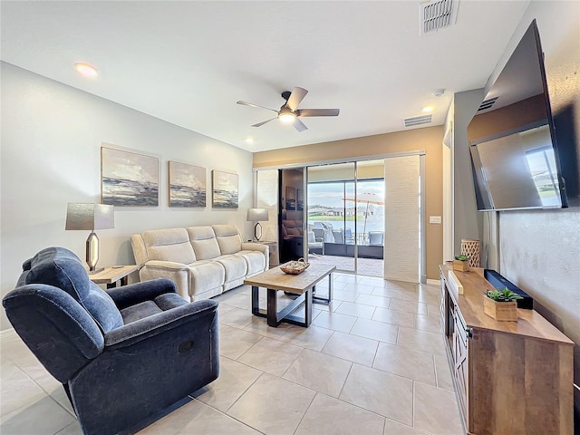 living room featuring light tile patterned floors, baseboards, visible vents, and a ceiling fan