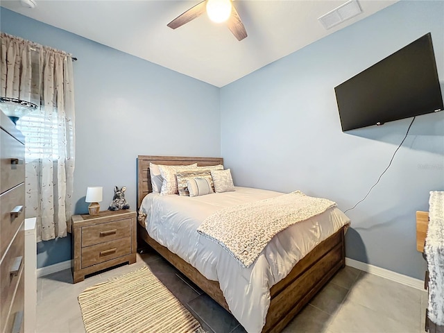 tiled bedroom featuring ceiling fan, visible vents, and baseboards