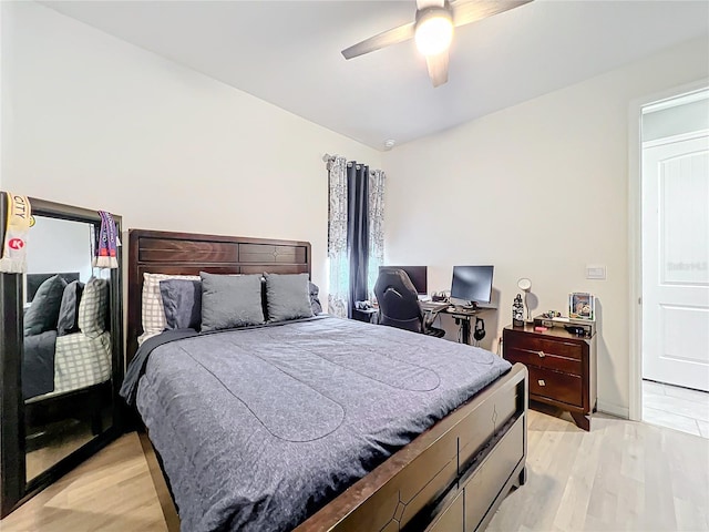 bedroom with a ceiling fan and light wood-style flooring