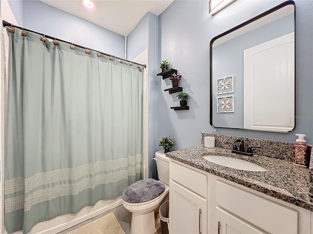 bathroom featuring curtained shower, vanity, and toilet