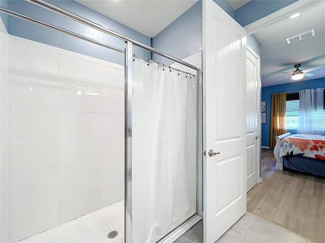 bathroom with tile patterned flooring, a shower stall, visible vents, and connected bathroom