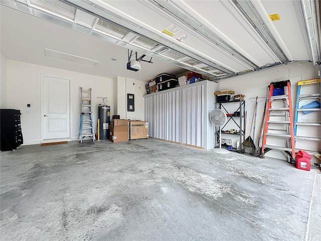 garage featuring a garage door opener and water heater