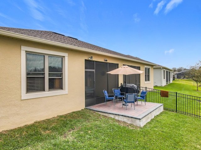 back of house featuring a patio, a shingled roof, fence, a yard, and stucco siding