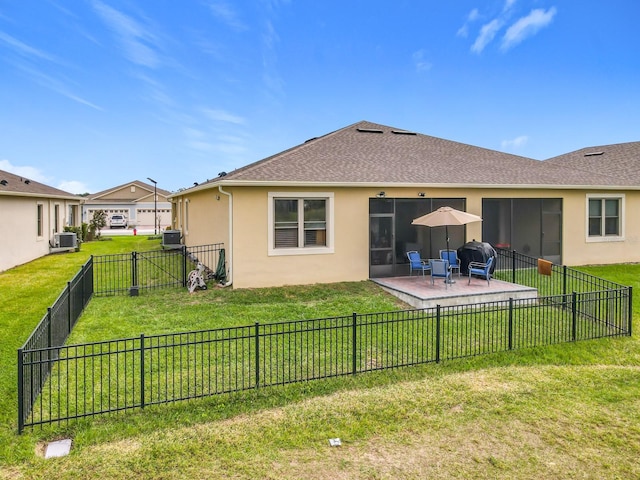 back of property with a lawn, a fenced backyard, roof with shingles, a patio area, and stucco siding