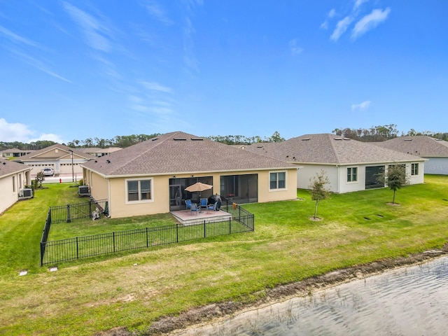 back of house featuring stucco siding, a fenced backyard, a lawn, and a patio