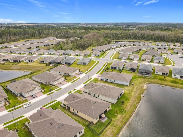 drone / aerial view featuring a water view and a residential view