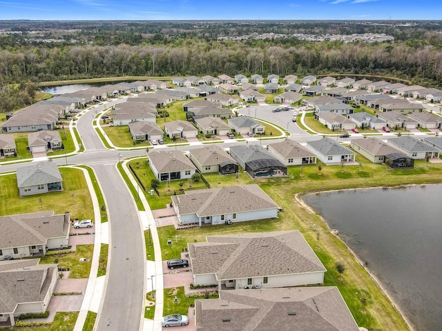 drone / aerial view with a water view and a residential view