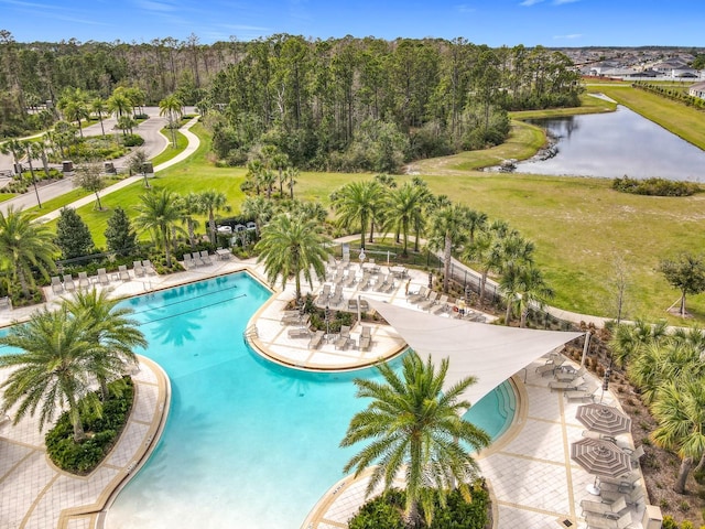 pool featuring a patio area and a water view