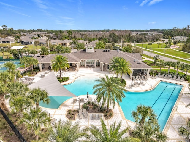 community pool featuring a gazebo, a patio area, fence, and a residential view