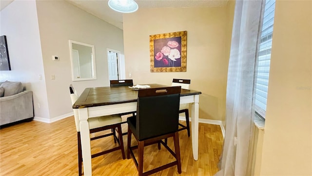 dining area featuring light wood-type flooring and baseboards