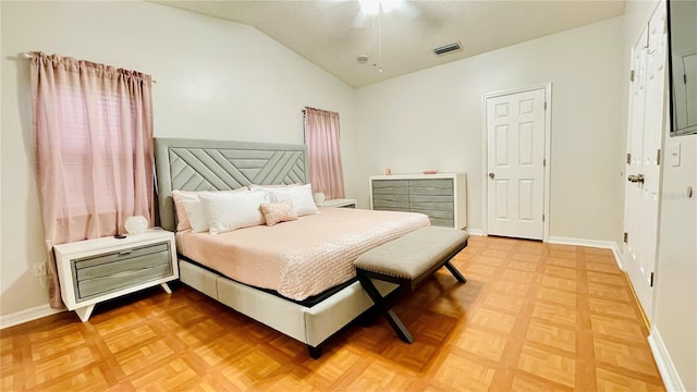 bedroom featuring lofted ceiling, visible vents, ceiling fan, and baseboards