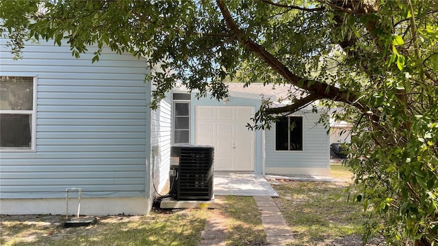 rear view of house featuring central AC unit