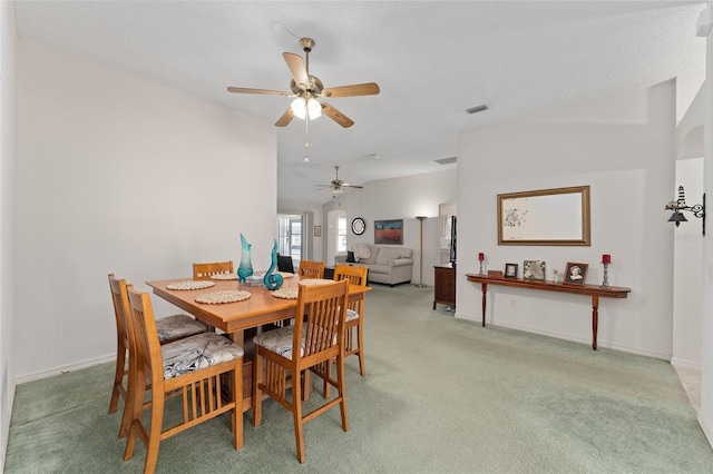 dining room featuring light carpet, baseboards, and visible vents