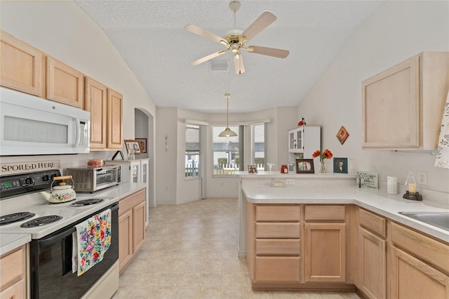 kitchen featuring white microwave, a peninsula, electric range, visible vents, and light brown cabinetry